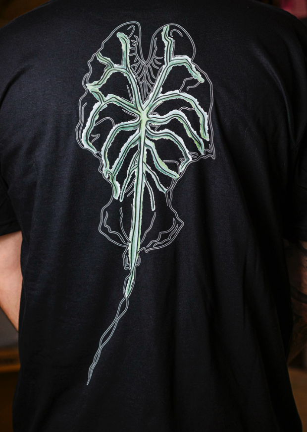 Alternative Black T-shirt featuring an Alocasia Venom Ghost Leaf for plant lovers. Shirt Created by RattTrap Artistry